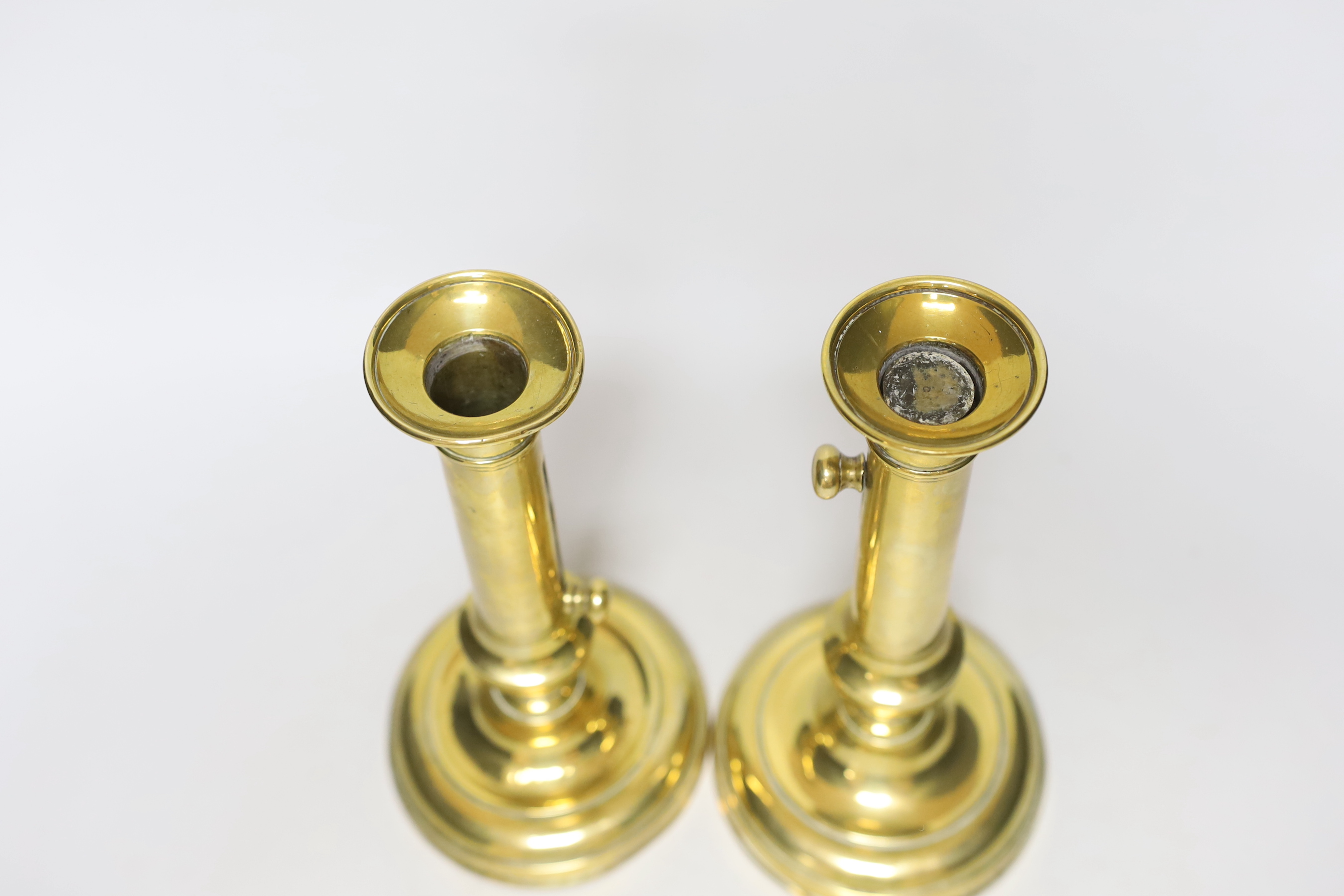 A pair of brass telescopic candlesticks, 23cm tall